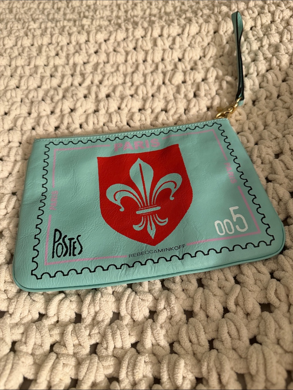 Rebecca Minkoff Turquoise Wristlet with Red Crest Graphic